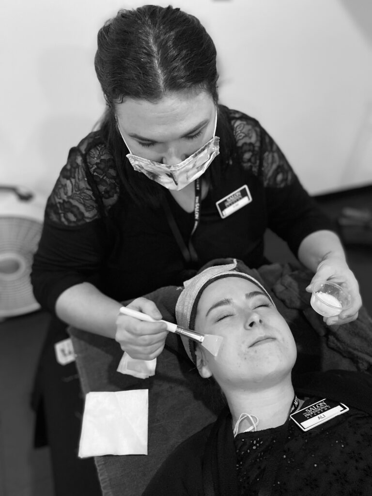 Salon Student Giving Circadia Skincare Line Facial - Black and White filter